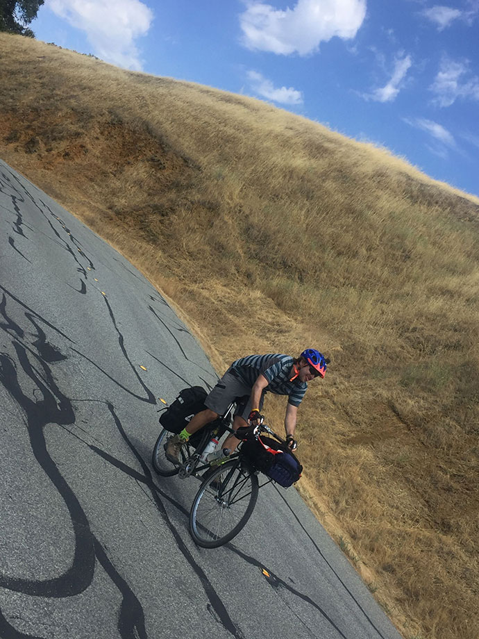 bikepacking cycling descending alpine road